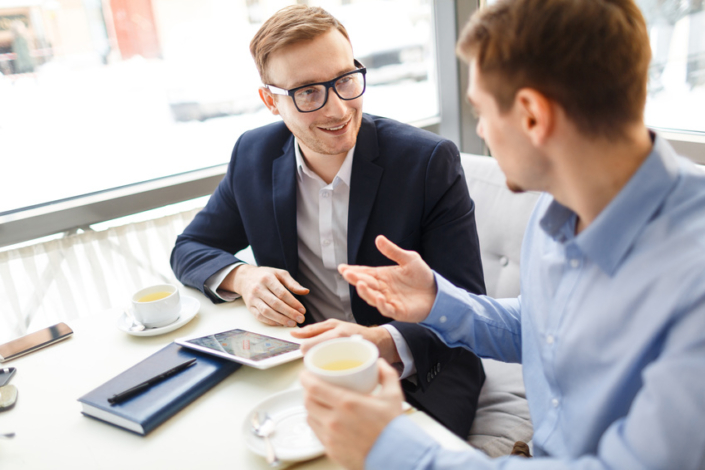 Business Colleagues Chatting in Cafe