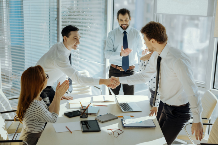Cheerful boss introducing participants of business meeting