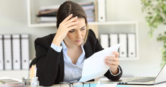 Worried executive reading a letter at office